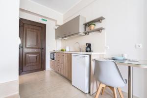 a small kitchen with a table and a chair at Casa Marina in Syvota