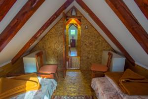 a attic room with two beds and a window at Vuković Accommodation in Žabljak