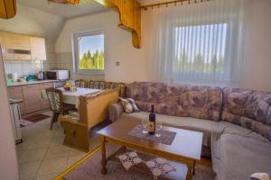 a living room with a couch and a table at Vuković Accommodation in Žabljak