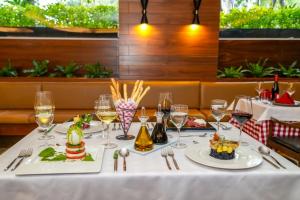 a table with plates of food and wine glasses at Barceló Mexico Reforma in Mexico City