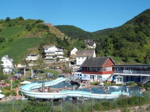 a large swimming pool with a water slide at Pension Restaurant Luna in Treis-Karden