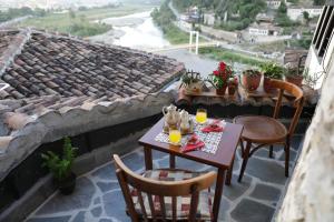 a table and chairs on a balcony with a view at Guest House Mikel in Berat +21 photos
