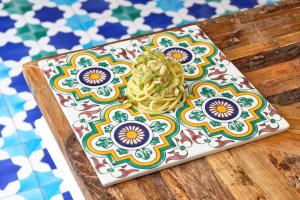 a plate with noodles on top of a table at Palazzo Gentilcore in Castellabate