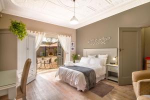 a bedroom with a bed and a table and chairs at Studio Gray in Benoni