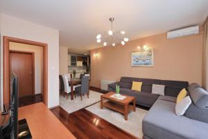 a living room with a couch and a table at Apartment Toni Zadar in Zadar