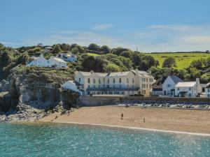 ein Gebäude an einem Strand neben dem Wasser in der Unterkunft Penthouse 16 At The Beach in Beesands