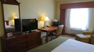 a hotel room with two beds and a television at Baymont Inn & Suites by Wyndham Holbrook in Holbrook