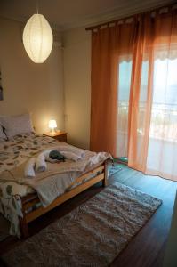 a bedroom with a bed with a rug and a window at Paradise View Apartment in Paleo Tsifliki