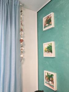 a blue wall with three pictures on it at Apartamento AGUA MARINA Levante Beach in Benidorm