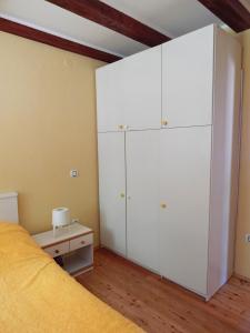 a bedroom with white cabinets and a bed at Apartment Porozina, Cres in Cres