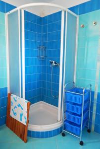 a blue bathroom with a tub and a shower at Apartment Porozina, Cres in Cres