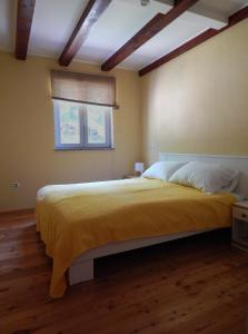 a bedroom with a large bed and a window at Apartment Porozina, Cres in Cres