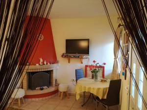 a living room with a table and a fireplace at Relaxing Beautiful Holiday Home in Lávrion