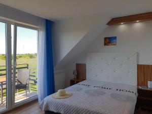 a bedroom with a bed and a large window at Holiday Amber - in Niechorze +64 photos