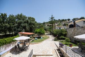 a view of a patio with chairs and umbrellas at Casa Marina in Syvota