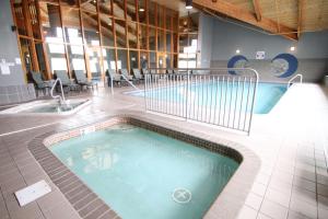 a large swimming pool in a building with two baths at C'mon Inn Billings in Billings