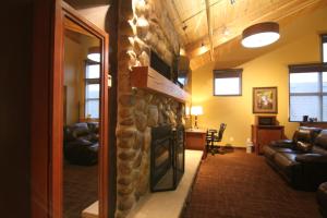a living room with a stone fireplace with a television at C'mon Inn Billings in Billings