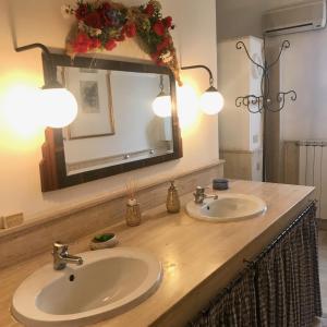 a bathroom with two sinks and a large mirror at Villa Sara di Puglia in Castellaneta +91 photos