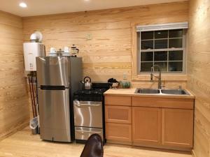 a kitchen with a stainless steel refrigerator and a sink at Little River Cabin in Sparta