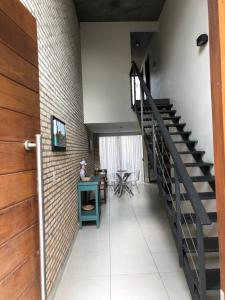 a hallway with a staircase and a table and chairs at Madre Natura in Asuncion
