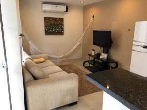 a living room with a couch and a tv at Madre Natura in Asuncion