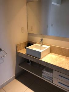 a bathroom with a sink and a mirror at Madre Natura in Asuncion