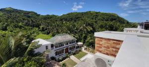 an aerial view of a house with a mountain at Bernardo's Lantia Hotel in Basco