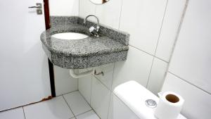 a bathroom with a sink and a toilet at Portal do Sol in Itaberaba
