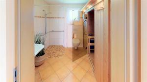 a bathroom with a shower and a toilet in it at Feriendorf Südstrand Haus 09 in Pelzerhaken +19 photos