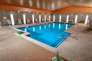 
a swimming pool with a pool table and chairs at Ramada Hotel & Conference Center by Wyndham Lewiston in Lewiston
