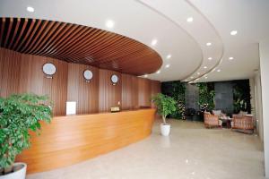 a lobby with a wooden reception desk and chairs at Chuồn Chuồn Resort Nghia Lo - Free Sauna & Onsen in Yên Bái +87 photos