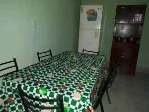 a kitchen with a table with a green and white table cloth at Hostel Odorico in San José +31 photos