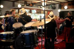 a group of people playing drums in a room at Ship Inn Motel in Yarram