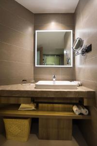 a bathroom with a sink and a mirror at Atour Hotel (Zhuji Xishi Hometown) in Shaoxing