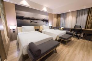 a hotel room with two beds and a piano at Atour Hotel (Zhuji Xishi Hometown) in Shaoxing