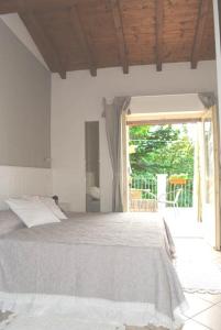 a bedroom with a bed and a large window at La Locanda Al Lago in Verbania