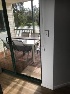 a kitchen with a table and chairs and a window at Riverview Tourist Park in Margaret River Town