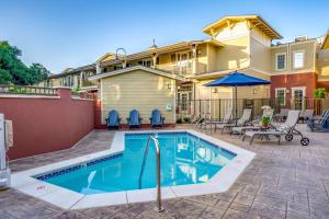a swimming pool in front of a house at The Agrarian Hotel; Best Western Signature Collection in Arroyo Grande