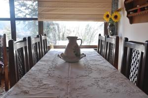 a table with a vase sitting on top of it at Kastraki Vacations House in Dimitsana