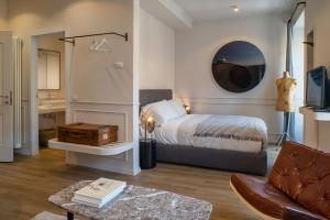 a bedroom with a bed and a living room at Suites Menaggio in Menaggio
