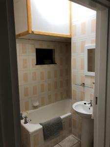 a bathroom with a bath tub and a sink at Sand Castle 2 in Margate