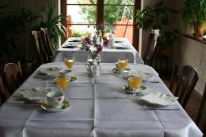 a long table with a white table cloth on it at Komblówka in Marcinowa Wola
