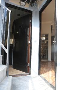 an open glass door of a building with a staircase at Apartment DURU in Batumi