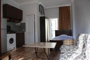 a small living room with a table and a couch at Apartment DURU in Batumi