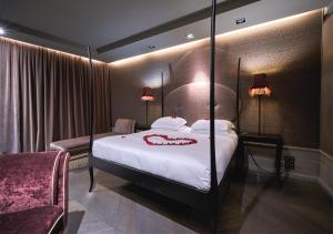 a bedroom with a large bed with a red heart on it at Hotel Palazzo Barbarigo Sul Canal Grande in Venice