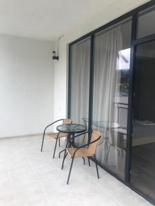 a table and chairs in a room with a window at Borjomi Central in Borjomi