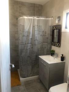 a shower curtain in a bathroom with a sink at AgiaNapaNest studio in Ayia Napa