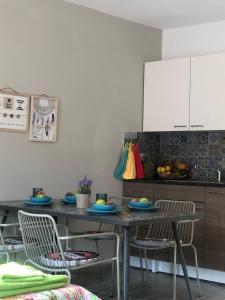 a kitchen with a table with chairs and a counter at AgiaNapaNest studio in Ayia Napa