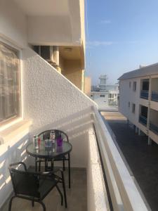 a table and chairs on the balcony of a building at AgiaNapaNest studio in Ayia Napa
