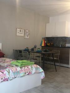 a room with a bed and a table and a kitchen at AgiaNapaNest studio in Ayia Napa